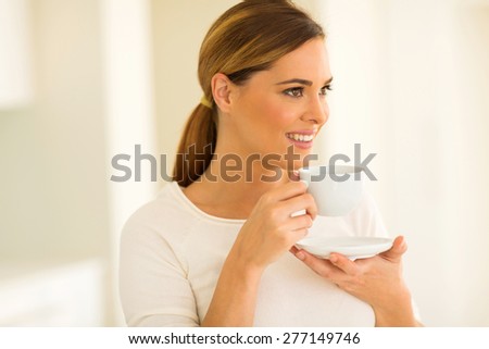 close up portrait of happy woman drinking coffee