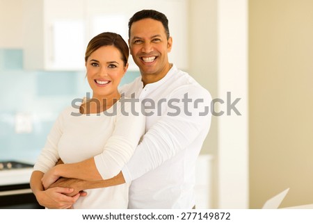 portrait of happy middle aged man hugging his wife