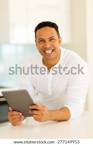 handsome man using tablet computer in the kitchen