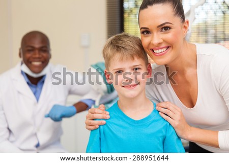 happy mother and son in dentist office