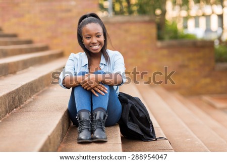 carefree pretty african college girl outdoors on campus