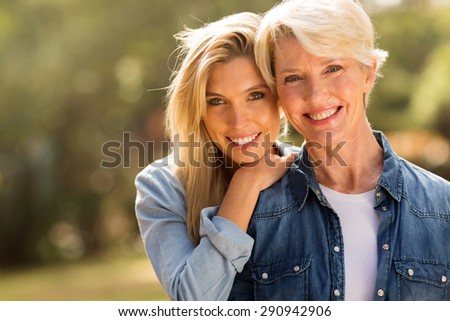 mature mother and young daughter looking at the camera
