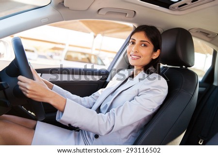 beautiful young indian woman driving a car