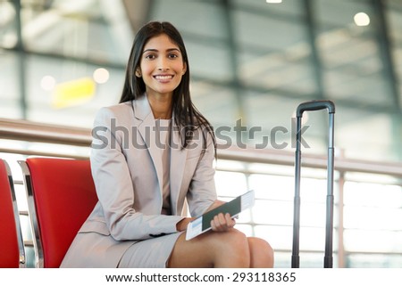 beautiful indian business woman waiting for her flight at airport