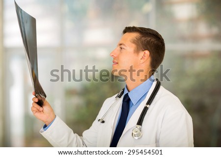 professional medical worker looking at patient\'s x-ray at hospital