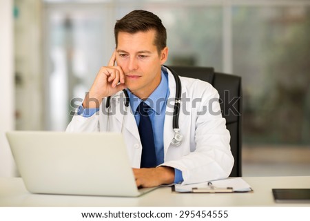 professional young medical doctor using laptop in office