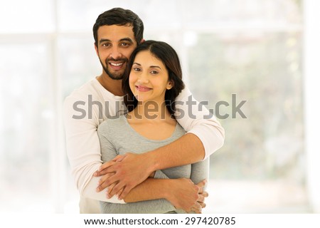 romantic indian couple hugging at home