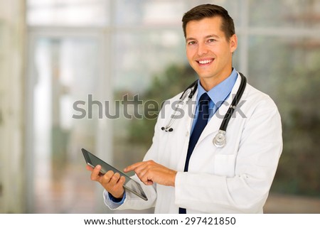 happy healthcare worker using tablet computer at hospital