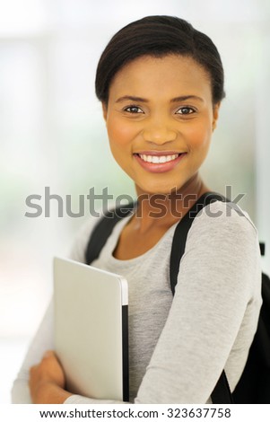 cheerful african american college student with laptop computer