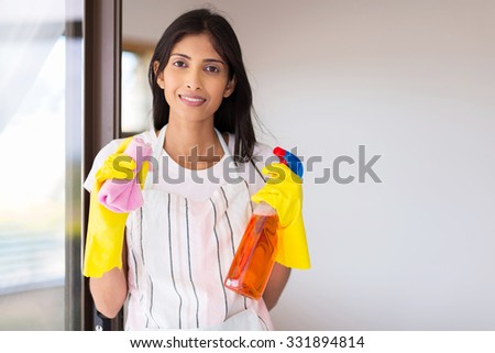 portrait of happy young indian woman doing housework