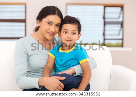portrait of beautiful indian mother and little boy sitting at home