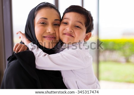 cute muslim boy hugging his mother