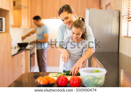 lovely young family preparing meal in kitchen