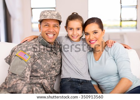 portrait of military family sitting on the couch at home