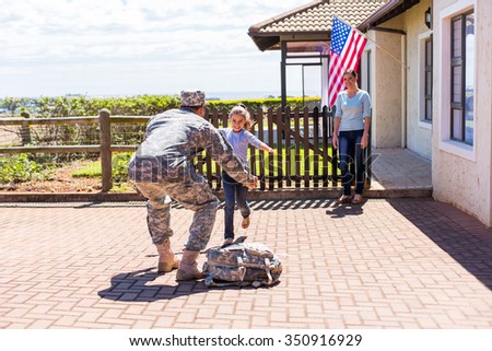 excited little girl running to her military father