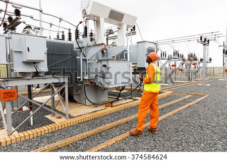 professional african electrician working in electrical substation