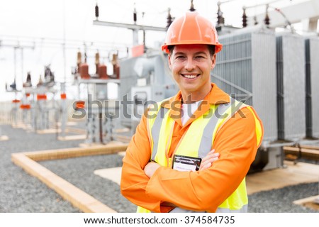 handsome electrical engineer arms crossed in substation