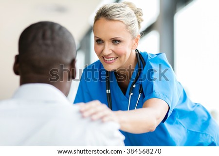 caring medical doctor comforting patient in office