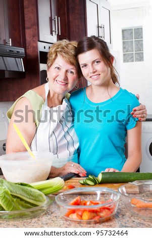 happy grandma and teen granddaughter portrait in kitchen