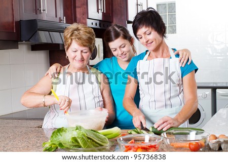 teen girl watching mother and grandmother cooking in kitchen