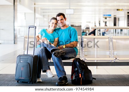 loving young couple waiting for flight at airport