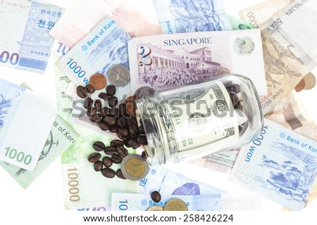 Coffee bean with Several bank notes of american singapore indonesian thai korean and coins isolate on white background