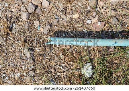 The old crack blue pipe on the dirty burn ground