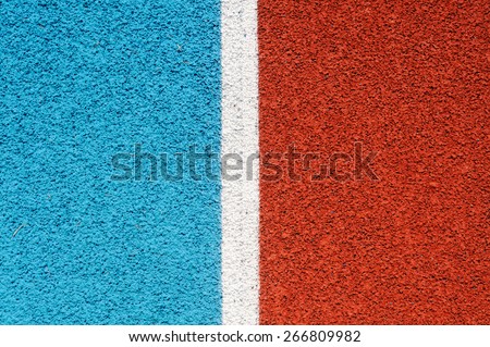 Running track made from red and blue granule rubber split by white line