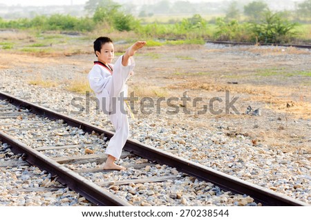 Asian boy practice taekwondo at the old rust railway area