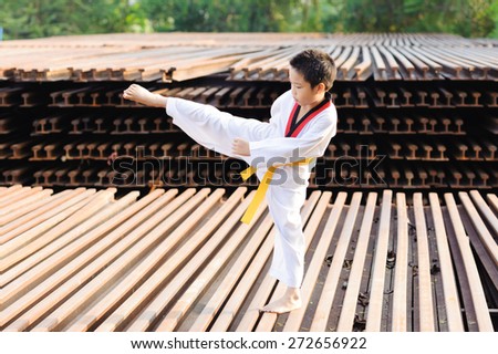 Asian boy practice taekwondo at the construction area