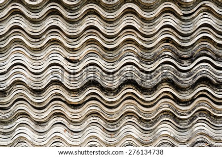 Old white concrete roof tile curve type stack on floor background