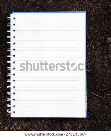 The old page ripped off from the notebook on soil background