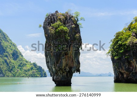 Rock hill and tree on green sea water in Phuket Thailand