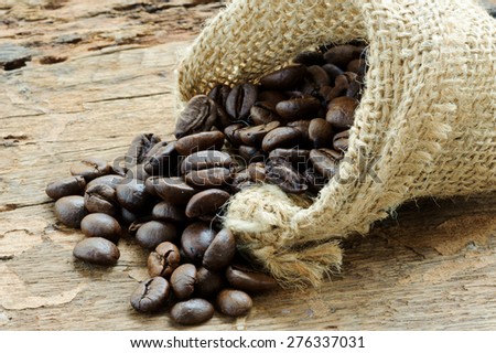 Close up thin focus on Coffee bean in bag on grunge wood table