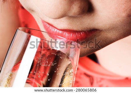 Close up thin focus on red lip Asian young woman drinking champagne