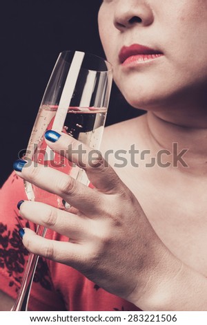 Sepia tone Close up red lip Asian young woman hold champagne in hand