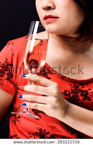 Close up red lip Asian young woman hold champagne in hand