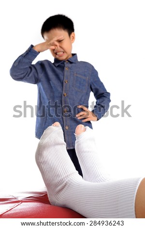 Out focus Boy feeling unhappy with bad smell white sock