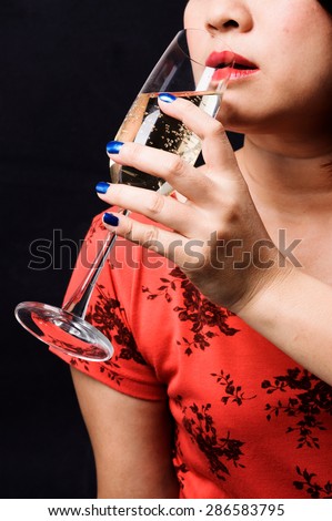 Close up red lip Asian young woman drinking champagne