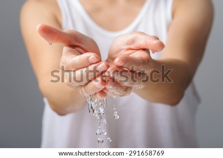 Thin focus Close up on woman hand and water drop and blur body in white shirt