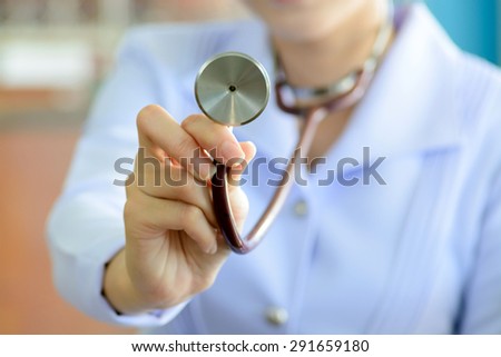 Close up thin focus to blur face of Stethoscope on young female doctor hand in white uniform