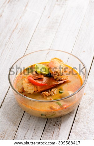 Tom Yum Goong - Famous and very delicious food that hot and spicy soup with shrimp that could easily found in most of resturant in Thailand, serve in glass bowl. Thai Cuisine