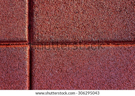 Close up of red used and old rubber floor of children play ground