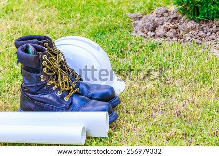 safety shoe and safety helmet on grass background