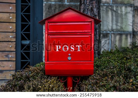red post box or mailbox postbox letterbox on the street