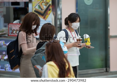 SEOUL, SOUTH KOREA - JUN 24, 2015: A tourist wearing a mask for protect from Mers virus in South  Korea, at Seoul station,Virus MERS, which has no known cure or vaccine.