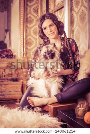 Beautiful Hipster Woman in classic interior with pomeranian(Dog). VIntage/Retro