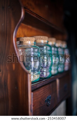 Colorful herbs,spices and aromatic ingredients on wooden shelf. Shallow depth of field.