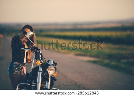 Beautiful woman on the motorcycle.Retro filter, washed out colors.