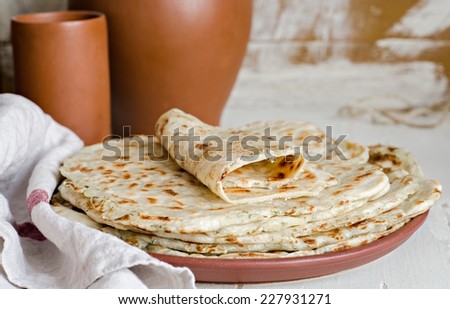 Homemade fried Indian bread  paratha on wooden background